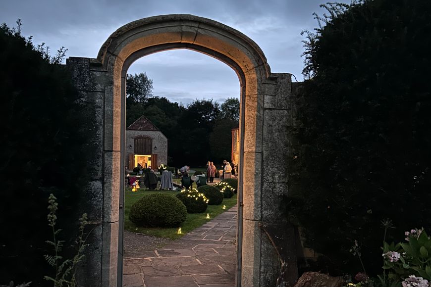 an archway leading to a garden
